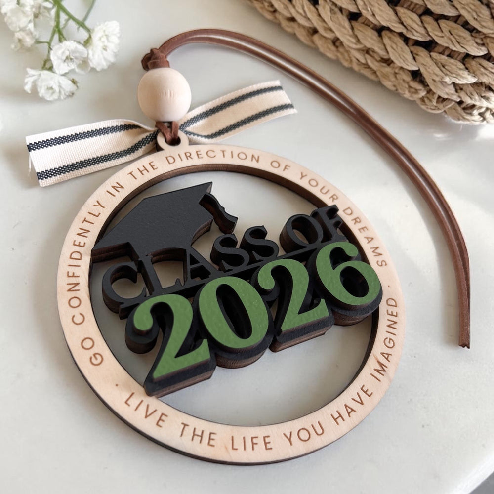 Graduation-themed ornament with 'Class of 2026' text on a light background