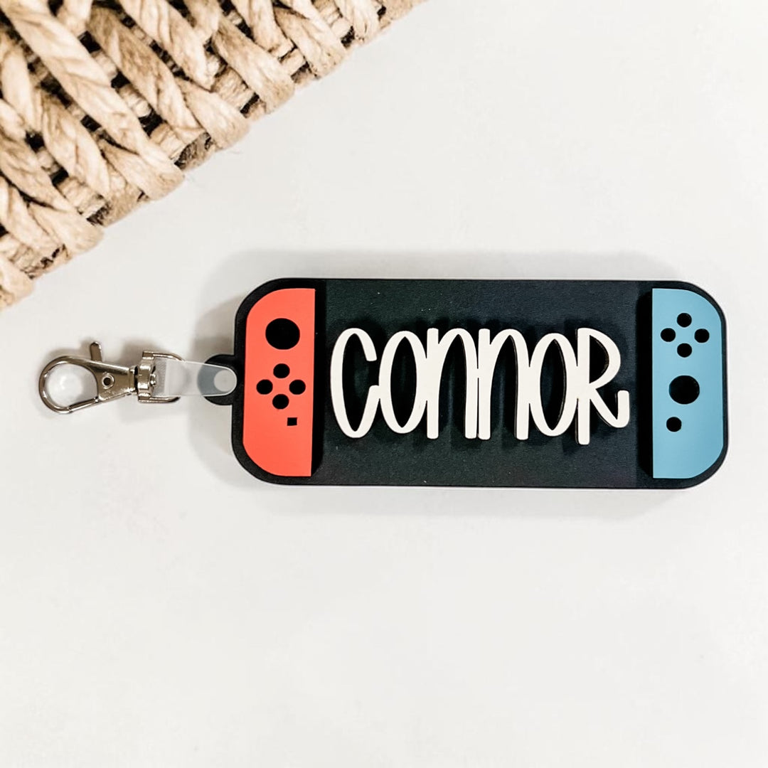 Keychain with 'Connor' text in the style of a gaming controller on a white background