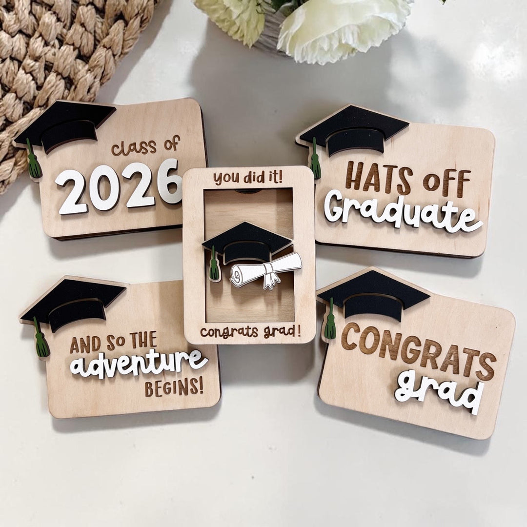 Graduation-themed gift card holder with text and graduation cap design on a white surface.
