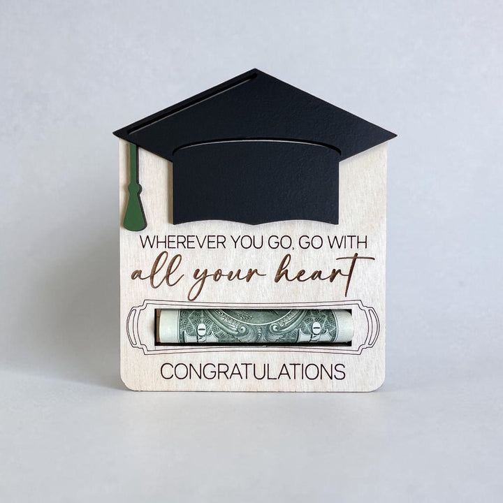 Graduation-themed money holder with a black cap and tassel on a light gray background